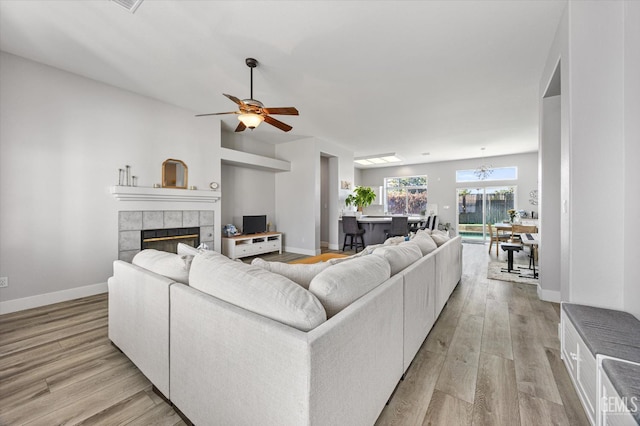 10809 Mirage Dr, Bakersfield, CA 93311 - living area featuring a fireplace, light wood-style floors, and a ceiling fan