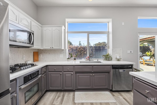 10809 Mirage Dr, Bakersfield, CA 93311 - kitchen featuring stainless steel appliances, gray cabinets, white cabinetry, and light wood finished floors