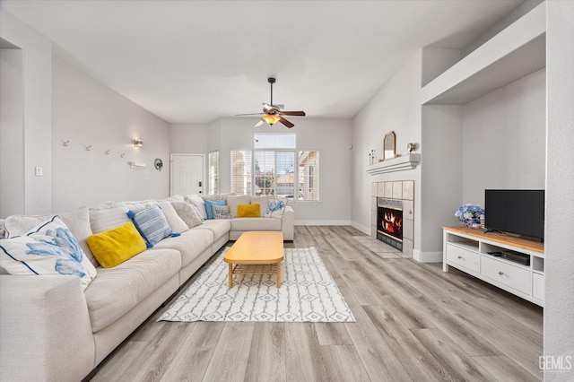 10809 Mirage Dr, Bakersfield, CA 93311 - living area with light wood-type flooring, a ceiling fan, and a fireplace
