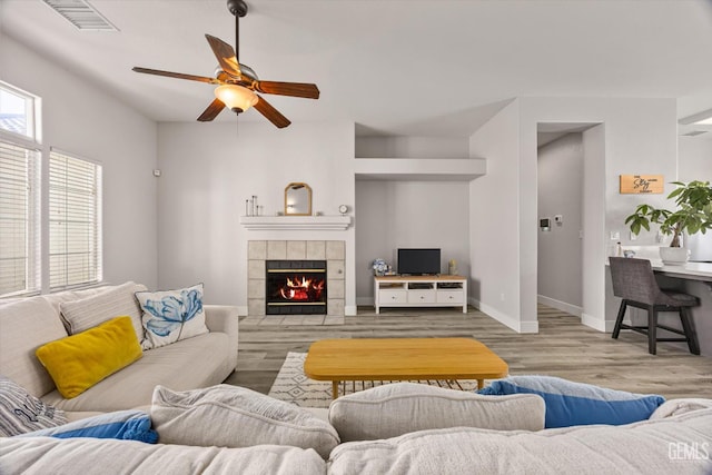 10809 Mirage Dr, Bakersfield, CA 93311 - living area with ceiling fan, a fireplace, and wood finished floors