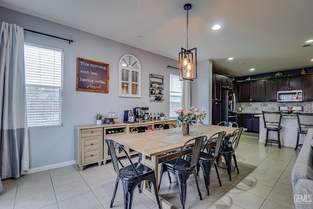 dining space featuring light tile patterned floors