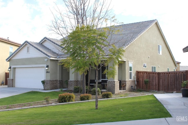 view of front of home with a front lawn, fence, brick siding, and stucco siding