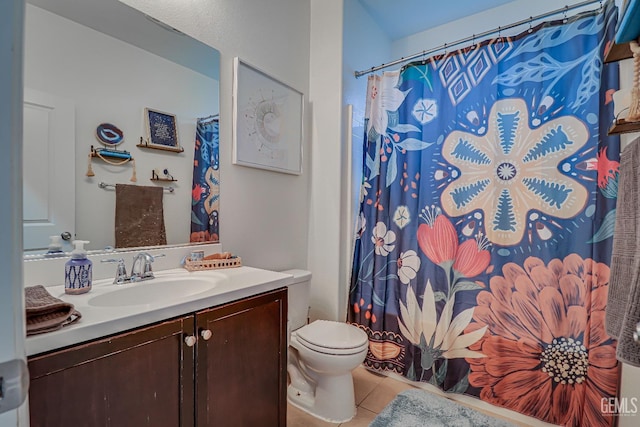 bathroom with a shower with shower curtain, vanity, toilet, and tile patterned flooring