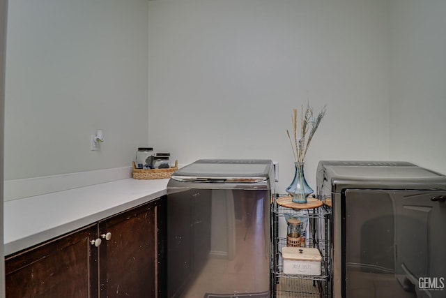 laundry area featuring cabinets and separate washer and dryer