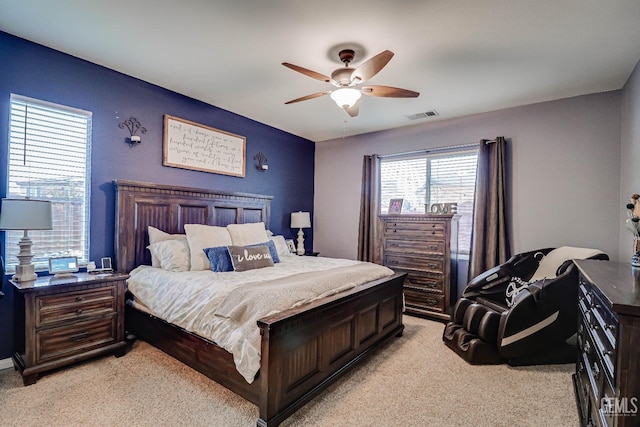 bedroom featuring light colored carpet and ceiling fan