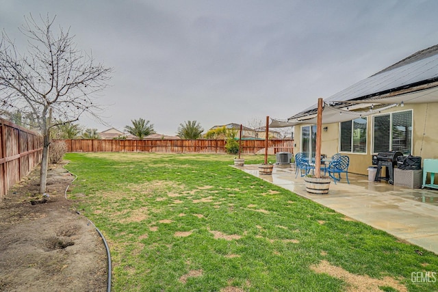 view of yard with a patio, central AC, and a fire pit