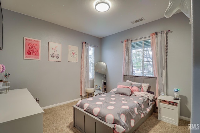 carpeted bedroom featuring multiple windows