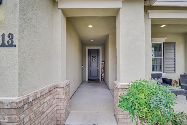 view of exterior entry with stucco siding