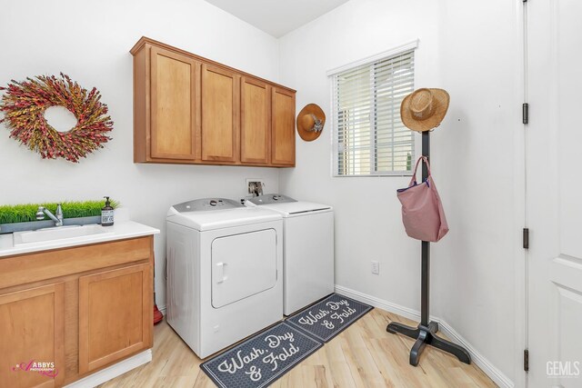 5903 Gold Ranch Way, Bakersfield, CA 93306 - laundry room featuring washing machine and clothes dryer, cabinet space, and light wood-type flooring