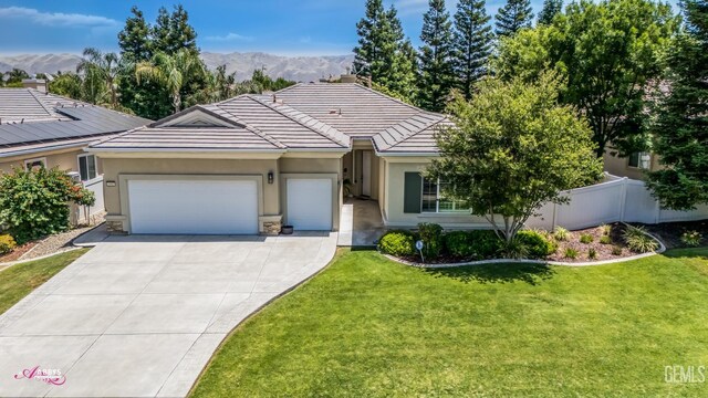 5903 Gold Ranch Way, Bakersfield, CA 93306 - ranch-style house featuring a garage, stucco siding, concrete driveway, a mountain view, and a tiled roof