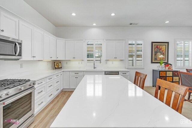 5903 Gold Ranch Way, Bakersfield, CA 93306 - kitchen featuring stainless steel appliances, a center island, recessed lighting, white cabinets, and light wood finished floors