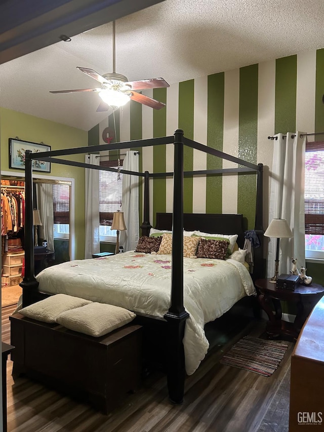 9125 Gleeson Ct, Bakersfield, CA 93311 - bedroom featuring wood finished floors, wallpapered walls, a spacious closet, ceiling fan, and a textured ceiling