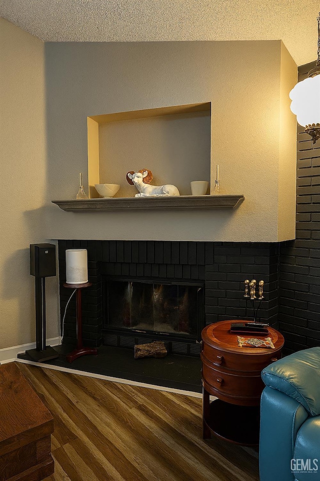 9125 Gleeson Ct, Bakersfield, CA 93311 - detailed view of wood finished floors, a textured ceiling, and a fireplace