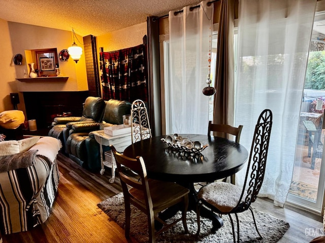 9125 Gleeson Ct, Bakersfield, CA 93311 - dining room with lofted ceiling, wood finished floors, and a textured ceiling