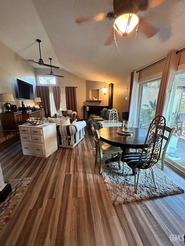 9125 Gleeson Ct, Bakersfield, CA 93311 - dining room with ceiling fan, dark wood-style flooring, lofted ceiling, plenty of natural light, and a textured ceiling