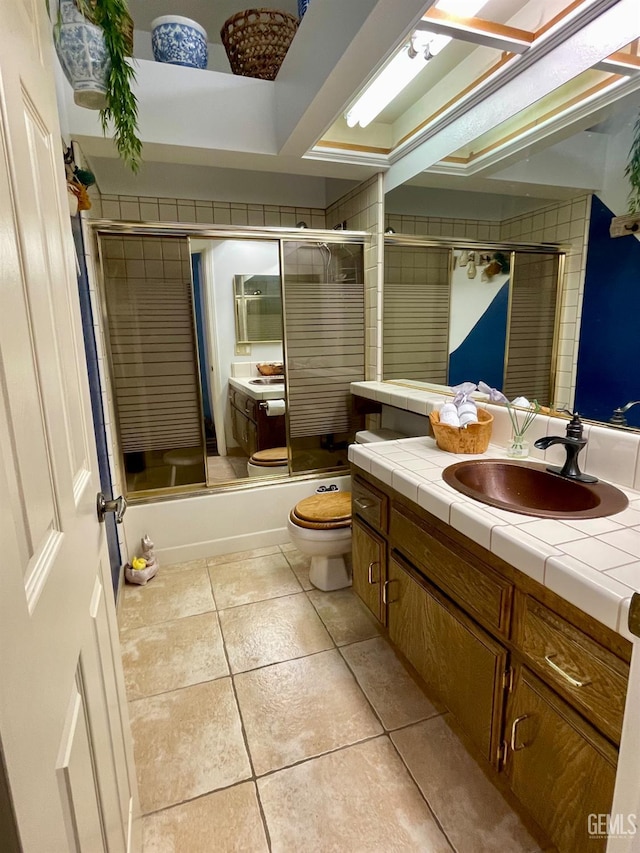 9125 Gleeson Ct, Bakersfield, CA 93311 - bathroom with vanity, toilet, combined bath / shower with glass door, and tile patterned flooring
