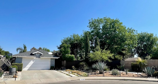 9125 Gleeson Ct, Bakersfield, CA 93311 - view of property hidden behind natural elements with concrete driveway and a garage