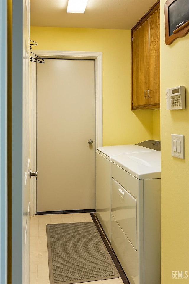 9125 Gleeson Ct, Bakersfield, CA 93311 - laundry area featuring cabinet space, washing machine and clothes dryer, and light tile patterned floors