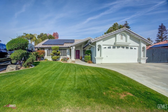 ranch-style house with solar panels, a garage, and a front yard