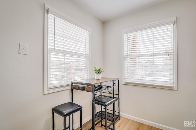 dining room with light wood-type flooring and baseboards