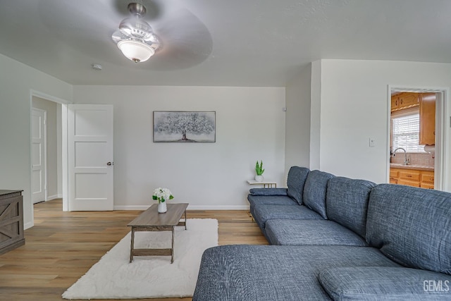 living room with light wood finished floors and baseboards