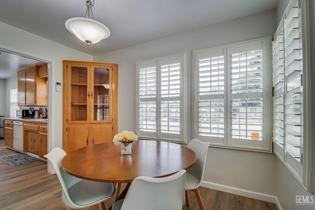 dining area with a healthy amount of sunlight, baseboards, and wood finished floors