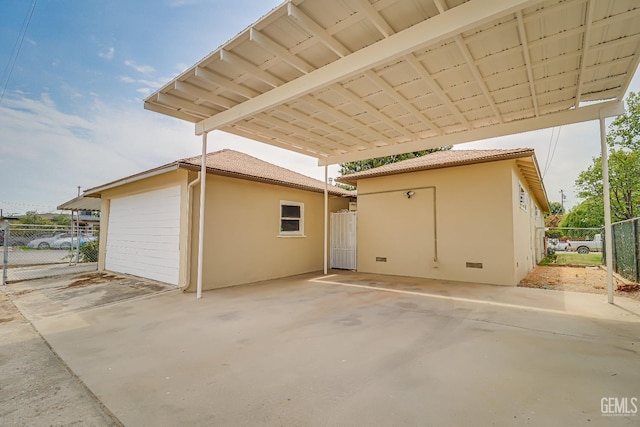 view of side of property featuring fence and stucco siding