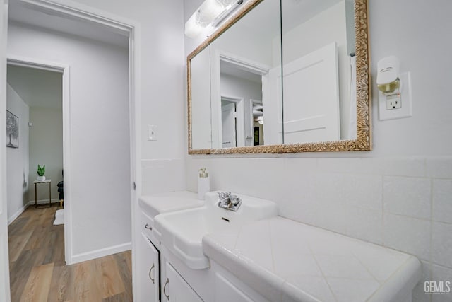 bathroom with wood finished floors and vanity