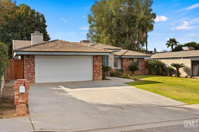 view of front of home with a front lawn and a garage