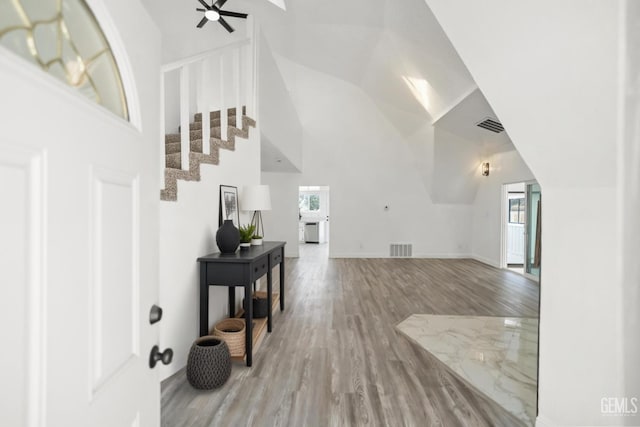 19701 Mesa Dr, Tehachapi, CA 93561 - entrance foyer with healthy amount of natural light, wood finished floors, a ceiling fan, high vaulted ceiling, and stairs