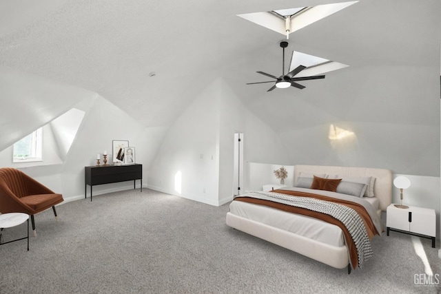 19701 Mesa Dr, Tehachapi, CA 93561 - carpeted bedroom featuring a skylight, vaulted ceiling, and ceiling fan
