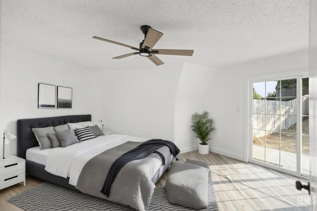 19701 Mesa Dr, Tehachapi, CA 93561 - bedroom with access to exterior, wood finished floors, a textured ceiling, and ceiling fan