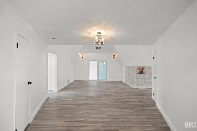 19701 Mesa Dr, Tehachapi, CA 93561 - bonus room with a chandelier, wood finished floors, and a textured ceiling
