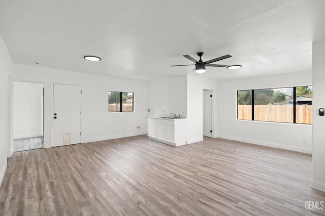 19701 Mesa Dr, Tehachapi, CA 93561 - unfurnished living room featuring a ceiling fan and light wood-type flooring
