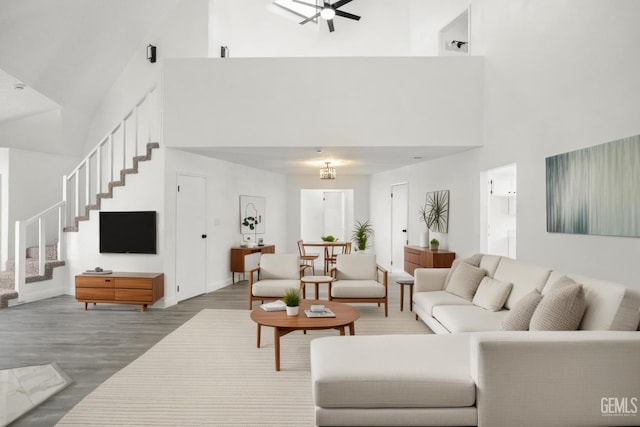 19701 Mesa Dr, Tehachapi, CA 93561 - living room with high vaulted ceiling, stairs, wood finished floors, and a ceiling fan