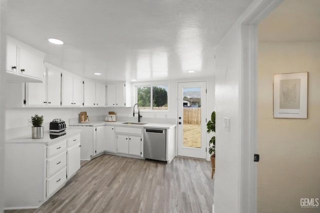 19701 Mesa Dr, Tehachapi, CA 93561 - kitchen featuring stainless steel dishwasher, light countertops, light wood-style flooring, white cabinets, and recessed lighting