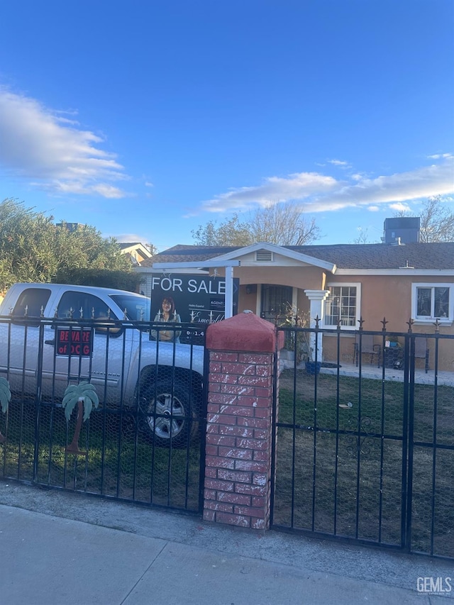 view of gate featuring a fenced front yard