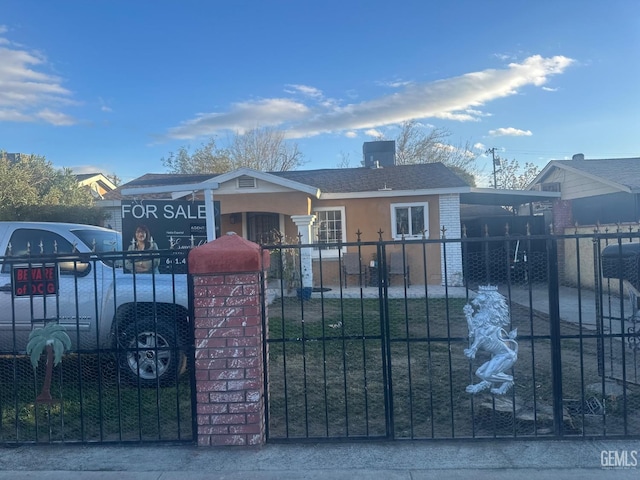 view of gate with a fenced front yard