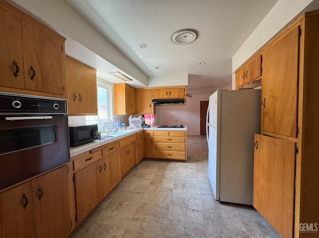 2701 Pinon St, Lake Isabella, CA 93240 - kitchen featuring tile counters, under cabinet range hood, a sink, and black appliances