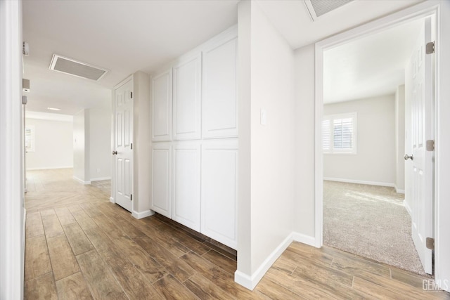 hall with hardwood / wood-style flooring