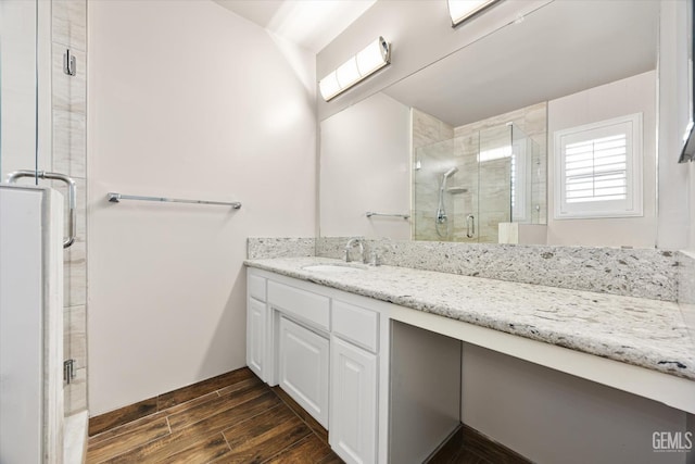 bathroom with vanity and a shower with door