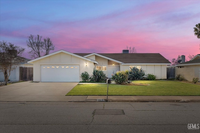 ranch-style house with a yard and a garage