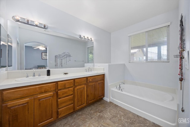 6202 Ocean Jasper Dr, Bakersfield, CA 93313 - full bathroom with double vanity, a garden tub, healthy amount of natural light, and ceiling fan