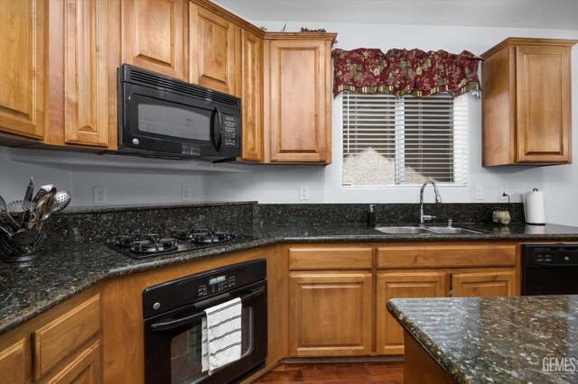 6202 Ocean Jasper Dr, Bakersfield, CA 93313 - kitchen featuring black appliances, dark stone countertops, dark wood-type flooring, and brown cabinetry