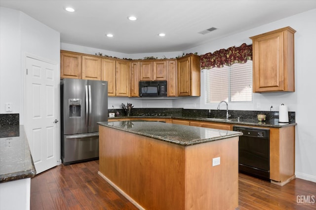 6202 Ocean Jasper Dr, Bakersfield, CA 93313 - kitchen with black appliances, dark wood-style floors, dark stone counters, recessed lighting, and a kitchen island