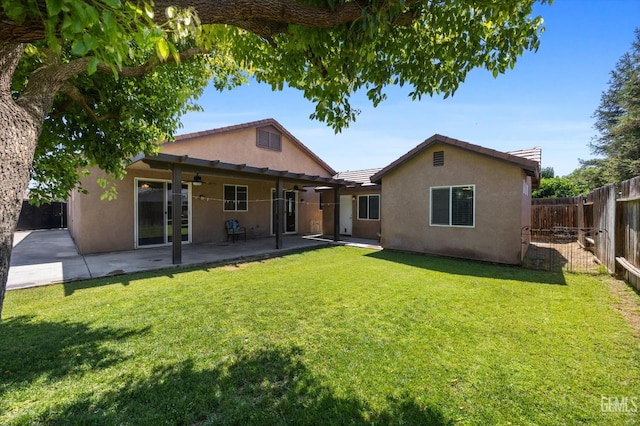 6202 Ocean Jasper Dr, Bakersfield, CA 93313 - back of property with a ceiling fan, stucco siding, a fenced backyard, a patio, and a tiled roof