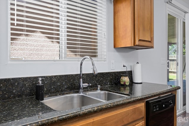 6202 Ocean Jasper Dr, Bakersfield, CA 93313 - kitchen with black dishwasher, brown cabinetry, healthy amount of natural light, and dark stone counters