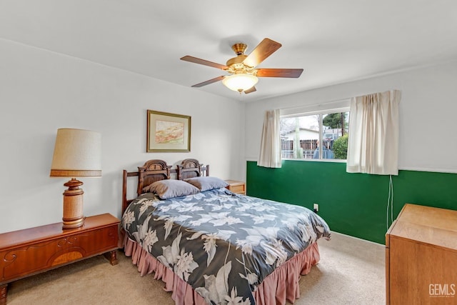 bedroom featuring light carpet and ceiling fan