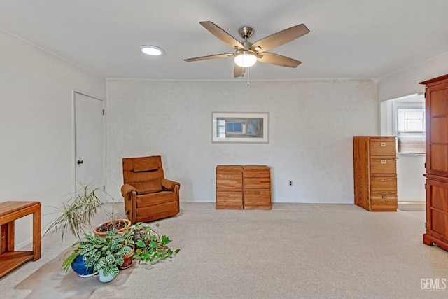 sitting room featuring carpet and ceiling fan