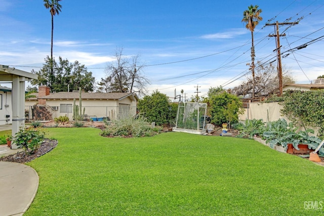 view of yard with a vegetable garden and fence